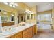 Bright bathroom with double vanity, soaking tub, and a window with decorative glass at 426 Buena Vista Rd, Golden, CO 80401