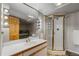 Bright bathroom showcasing a framed shower, vanity with a large mirror, and stone floors at 426 Buena Vista Rd, Golden, CO 80401