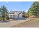 Charming two-story home featuring a three-car garage, a well-manicured lawn, and mature trees at 426 Buena Vista Rd, Golden, CO 80401