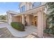 Inviting front porch with brick columns, mature shrubbery, and a quaint seating area at 426 Buena Vista Rd, Golden, CO 80401