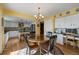 Spacious kitchen flowing into the dining area, featuring an island and plenty of natural light at 426 Buena Vista Rd, Golden, CO 80401