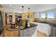 Open kitchen area with a granite island, stainless steel appliances, and hardwood floors at 426 Buena Vista Rd, Golden, CO 80401