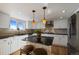 Bright kitchen featuring a center island, stainless steel appliances, and a window with a scenic view at 426 Buena Vista Rd, Golden, CO 80401