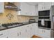 Gourmet kitchen with black countertops, stainless steel appliances, and ample cabinet space at 426 Buena Vista Rd, Golden, CO 80401