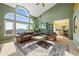 Bright living room featuring large windows, vaulted ceilings, comfortable seating, and views leading to a kitchen at 426 Buena Vista Rd, Golden, CO 80401