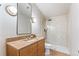 Bathroom featuring tiled shower and stone-topped vanity at 8120 W 54Th Pl, Arvada, CO 80002