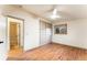 Bright bedroom with wood floors, built-in storage, and a view of the outdoors at 8120 W 54Th Pl, Arvada, CO 80002