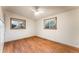 Bright bedroom features hardwood floors, white walls, ceiling fan, and two windows at 8120 W 54Th Pl, Arvada, CO 80002