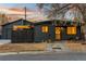 Charming home featuring a dark exterior, inviting front yard, and cozy outdoor lighting, perfect for evening enjoyment at 8120 W 54Th Pl, Arvada, CO 80002