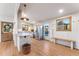 Modern kitchen features white cabinetry, stainless steel appliances, and hardwood floors for a stylish cooking space at 8120 W 54Th Pl, Arvada, CO 80002