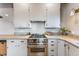 Well-equipped kitchen with stainless steel stove, ample counter space, and modern cabinetry at 8120 W 54Th Pl, Arvada, CO 80002