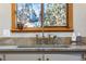 Detailed shot of the kitchen sink and window, highlighting the fixtures and natural light at 8120 W 54Th Pl, Arvada, CO 80002