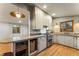 Bright kitchen with updated appliances, countertops, and hardwood floors, offering a clean and modern cooking area at 8120 W 54Th Pl, Arvada, CO 80002