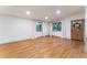 Bright living room featuring hardwood floors, crisp white walls, and large windows with light curtains, inviting natural light at 8120 W 54Th Pl, Arvada, CO 80002