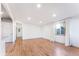 An airy living area with hardwood floors, white walls, and natural light creating a bright and welcoming space at 8120 W 54Th Pl, Arvada, CO 80002