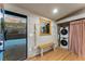Mud Room with Washer/Dryer, window, bench seat and access to outside deck at 8120 W 54Th Pl, Arvada, CO 80002