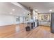 Open-concept area with hardwood floors, modern lighting, and an island, perfect for living, cooking, and entertaining at 8120 W 54Th Pl, Arvada, CO 80002
