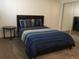 Comfortable bedroom with a blue comforter set, carpet, and mirrored closet doors, offering a cozy retreat at 9240 E Girard Ave # 1, Denver, CO 80231
