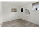 Well-lit room with gray floors, a front door, and a charming floral picture at 9240 E Girard Ave # 1, Denver, CO 80231