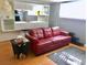 Inviting living room featuring a stylish red sofa, sleek furniture, and ample natural light at 9240 E Girard Ave # 1, Denver, CO 80231
