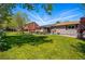 View of the home's exterior and backyard, highlighting the outdoor living space and surrounding greenery at 6655 S Elm Cir, Centennial, CO 80121