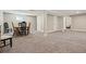 Spacious carpeted basement with dining table, chairs, and multiple entryways at 6655 S Elm Cir, Centennial, CO 80121
