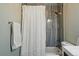Bathroom featuring a tub with shower head and white shower curtain with floral pattern at 6655 S Elm Cir, Centennial, CO 80121