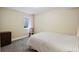 Bedroom with striped bedding, accent chair, and natural light from window at 6655 S Elm Cir, Centennial, CO 80121