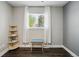 Charming bedroom featuring hardwood floors, a window view, and a stylish bookshelf at 6655 S Elm Cir, Centennial, CO 80121