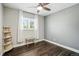 Bright bedroom with hardwood floors, a comfortable window bench, and a stylish bookshelf at 6655 S Elm Cir, Centennial, CO 80121