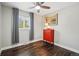 Well-lit bedroom featuring hardwood floors, a window view, a decorative dresser, and ceiling fan at 6655 S Elm Cir, Centennial, CO 80121