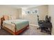 Bedroom featuring a computer setup, soft carpet, and natural lighting at 6655 S Elm Cir, Centennial, CO 80121