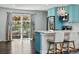 Bright and airy kitchen with a bar that overlooks an outdoor patio, perfect for entertaining at 6655 S Elm Cir, Centennial, CO 80121