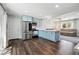 Open-concept kitchen flows into the living area, featuring a full suite of stainless steel appliances at 6655 S Elm Cir, Centennial, CO 80121