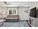 Cozy living room featuring a large window and an entertainment center at 6655 S Elm Cir, Centennial, CO 80121