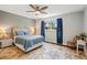 Comfortable main bedroom featuring hardwood floors, a ceiling fan, and a cozy rocking chair at 6655 S Elm Cir, Centennial, CO 80121