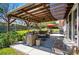 Covered patio with comfortable seating, outdoor dining area, and well-maintained lawn at 6655 S Elm Cir, Centennial, CO 80121