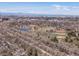 Expansive aerial view showcasing a serene neighborhood with parks, a lake, and the Denver skyline, creating a peaceful environment at 1594 S Locust St, Denver, CO 80224