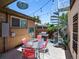 Backyard patio featuring a glass dining table, grill, spiral staircase and hanging decorative light at 1594 S Locust St, Denver, CO 80224