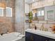 Charming bathroom featuring patterned tiles, a modern sink, and stylish fixtures at 1594 S Locust St, Denver, CO 80224