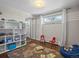 Bright and spacious bedroom featuring a large window, a striped accent wall, and hardwood floors at 1594 S Locust St, Denver, CO 80224
