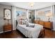 Cozy bedroom with hardwood floors, neutral walls, and lots of natural light at 1594 S Locust St, Denver, CO 80224