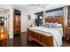 Inviting bedroom with a wood-frame bed, hardwood floors, and natural light from the window at 1594 S Locust St, Denver, CO 80224