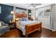 Comfortable primary bedroom with hardwood floors, natural light, and stylish furnishings for relaxation at 1594 S Locust St, Denver, CO 80224