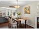 Elegant dining room with hardwood floors, stylish lighting, and a view into the adjacent living space at 1594 S Locust St, Denver, CO 80224