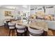 Open-concept kitchen boasts granite countertops, a large island, and views into the dining and living area at 1594 S Locust St, Denver, CO 80224