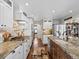 Bright kitchen with white cabinets, wood backsplash, and granite countertops offers ample space and modern style at 1594 S Locust St, Denver, CO 80224
