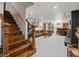 Finished basement with stairs leading to an open living area with a bar and seating at 1594 S Locust St, Denver, CO 80224