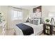 Well-lit bedroom with a bed, nightstands, and stylish wall art at 22293 E 6Th Pl, Aurora, CO 80018