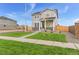 Two-story house with gray siding, stone accents, and a landscaped lawn at 22293 E 6Th Pl, Aurora, CO 80018